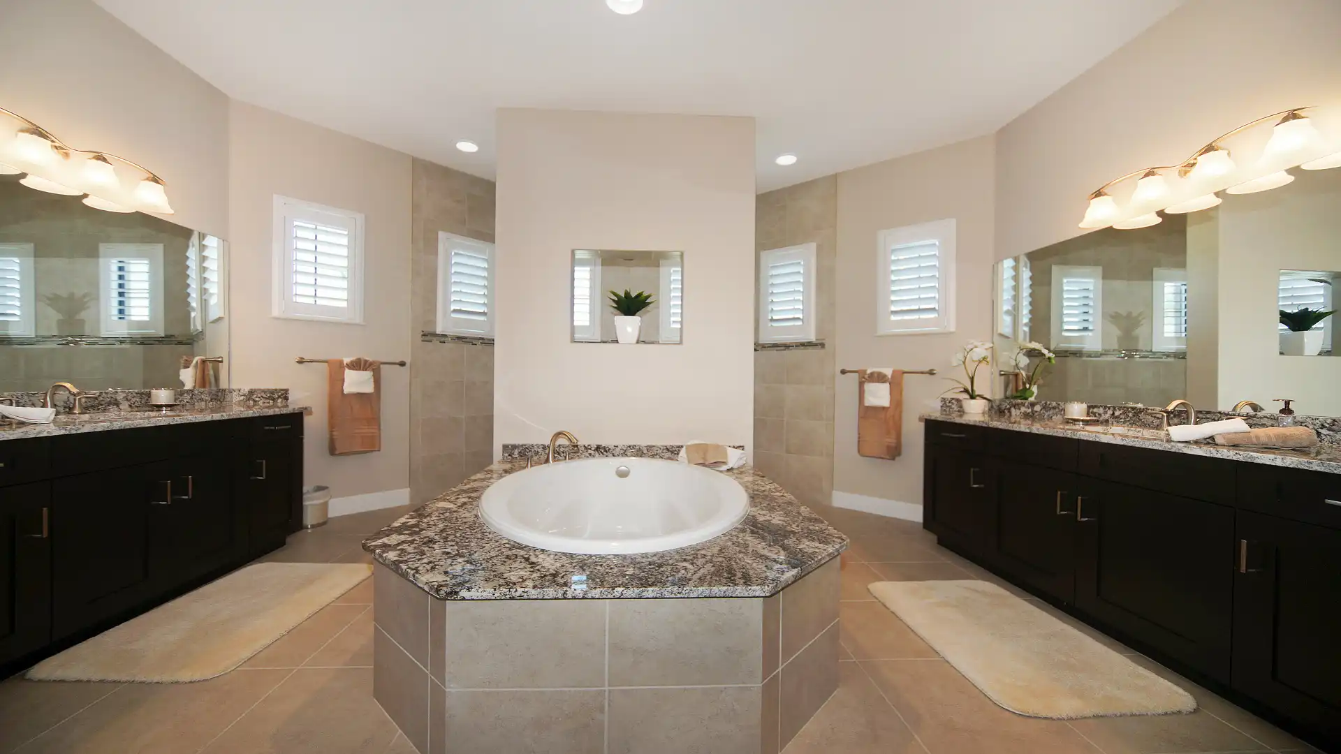 Luxurious bathroom with a large whirlpool bathtub, double sinks, and elegant mirrors.