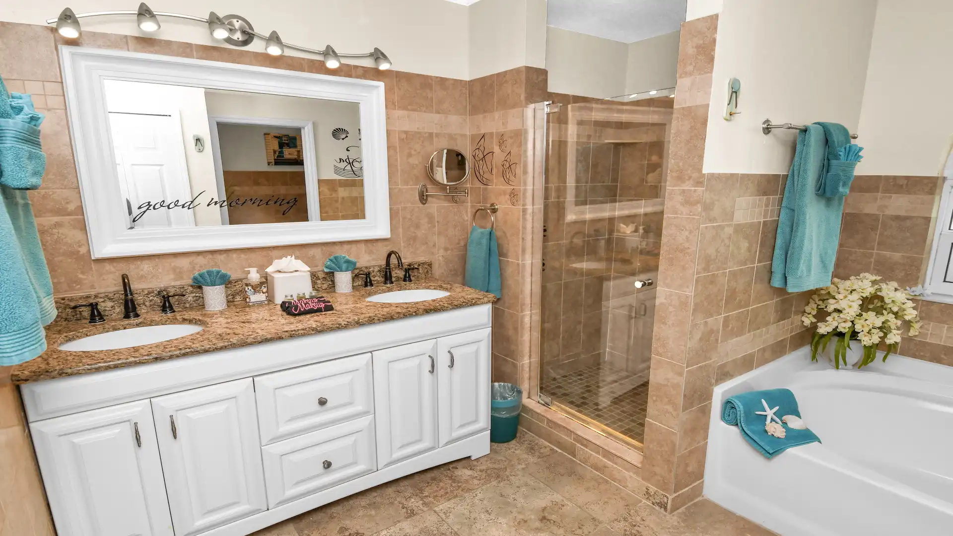 The adjoining bathroom boasts a shower and double washbasin