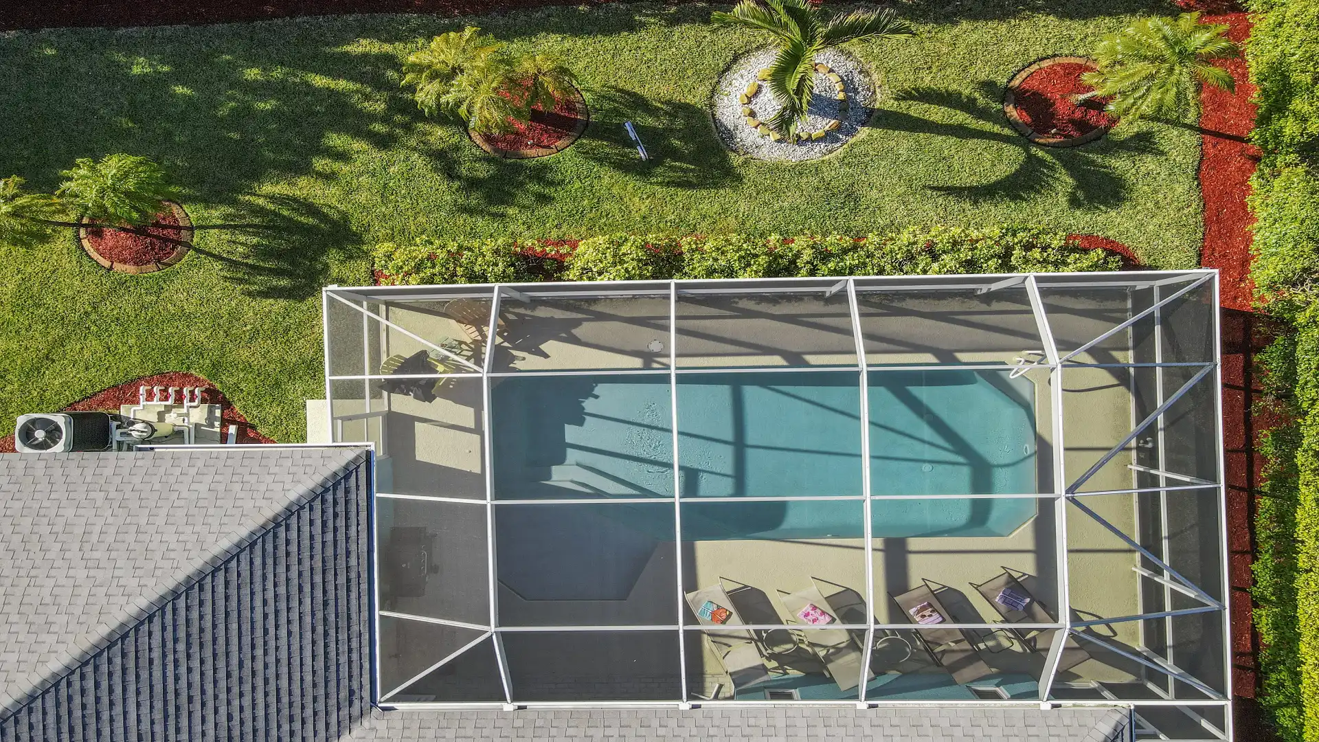 Private pool with screen, surrounded by tropical garden and sunshine