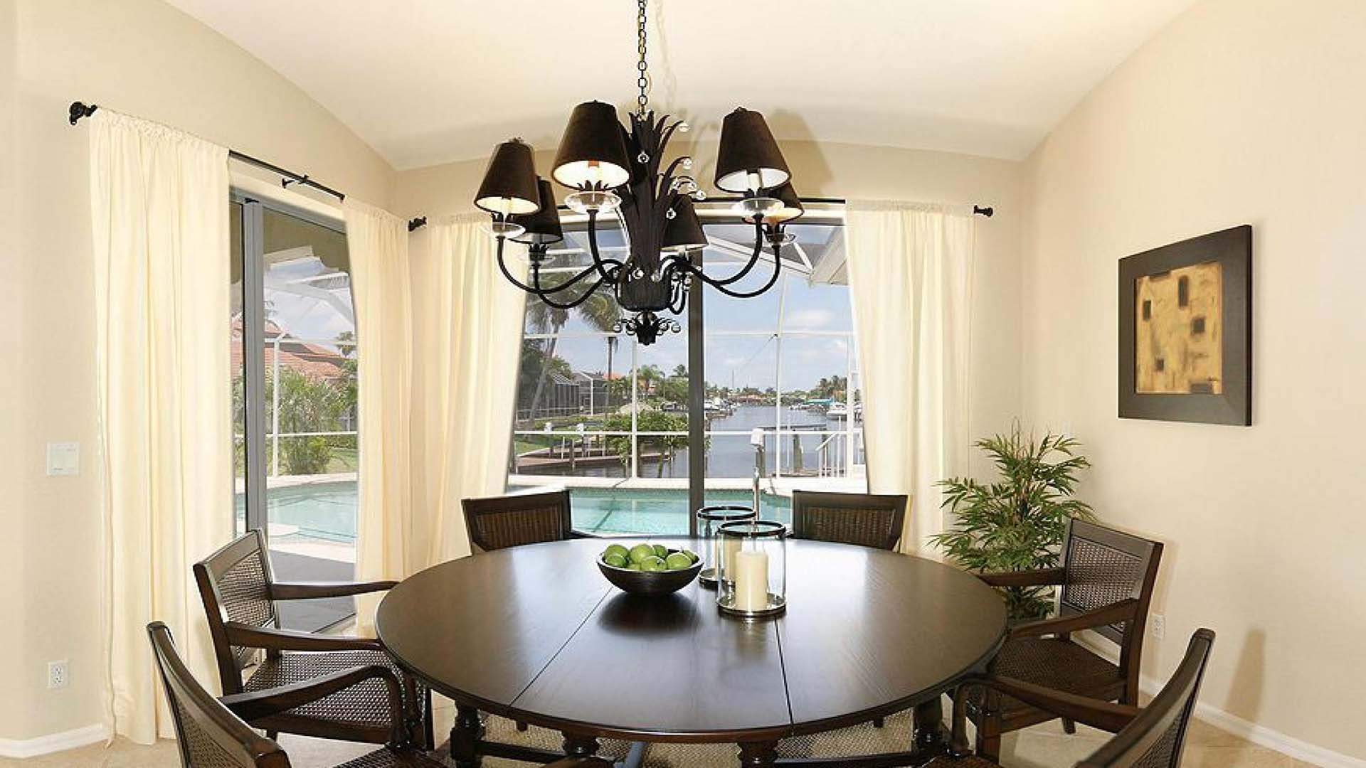 The dining area overlooks pool and sailboat canal