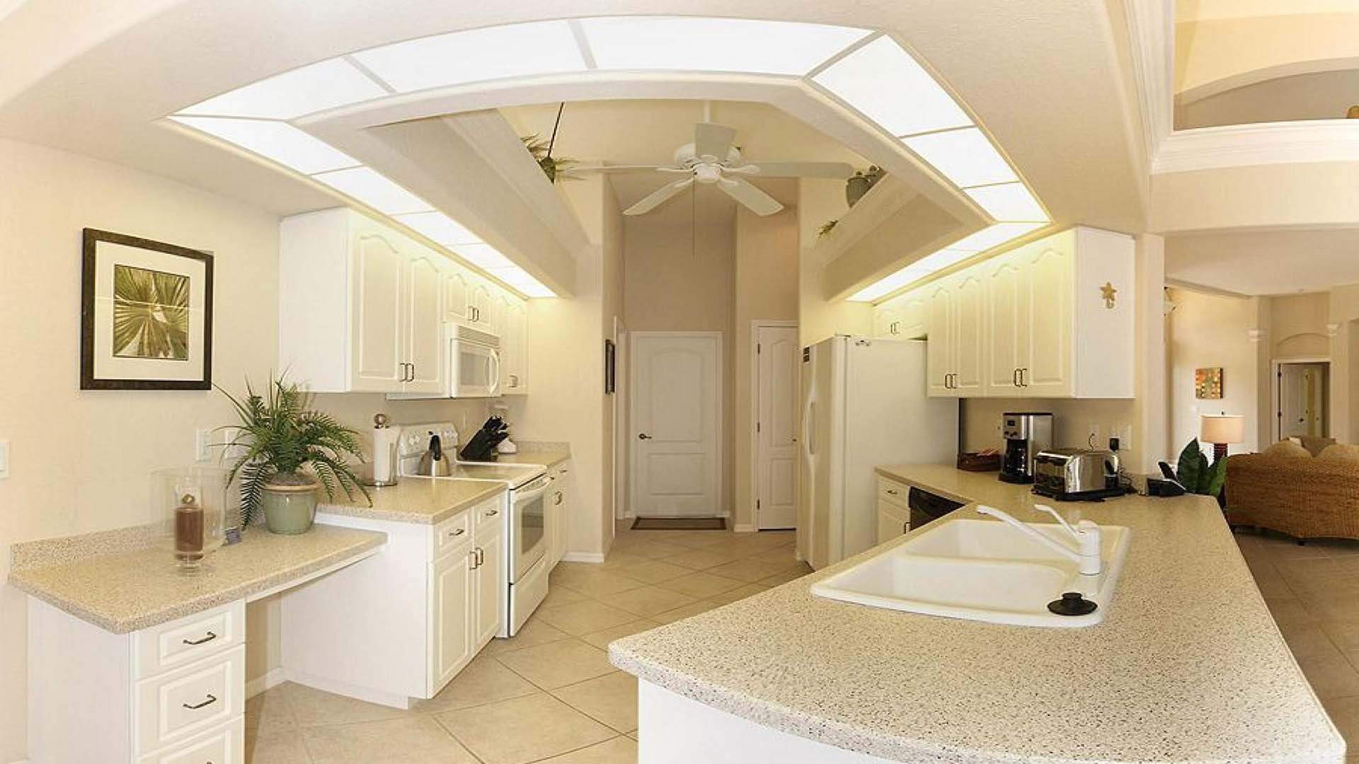 The elegant white kitchen is fully equipped