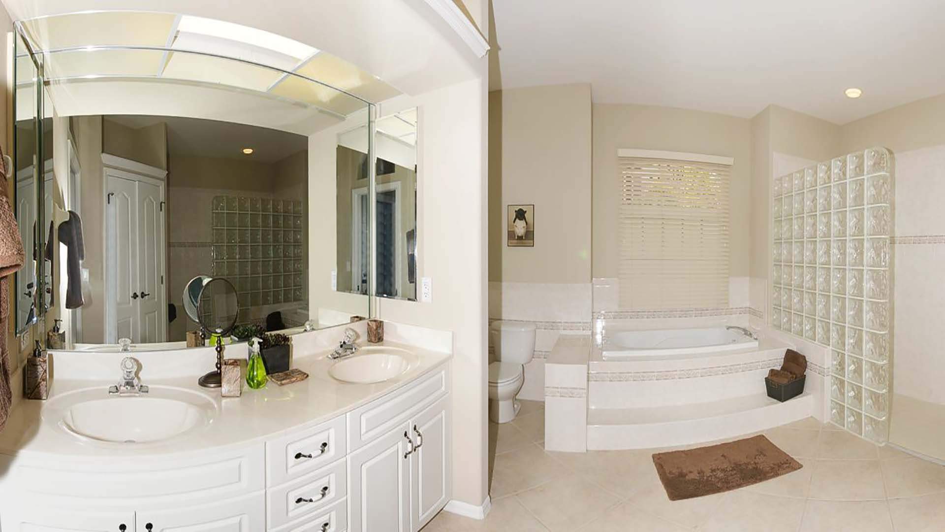The master bath includes a tub, a glass block walk-in shower and double sinks