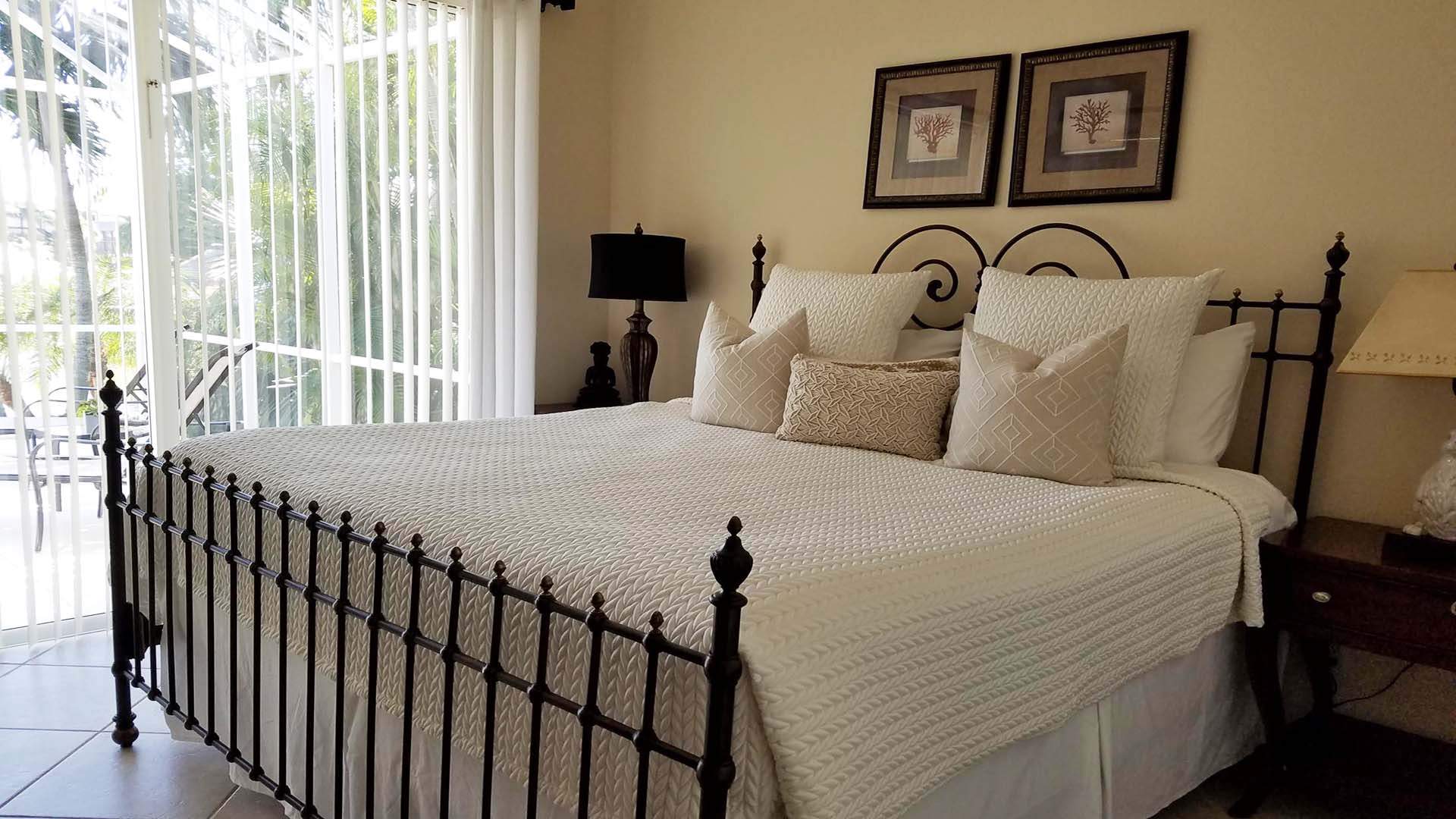 The second bedroom features another King size bed and leads out to the patio