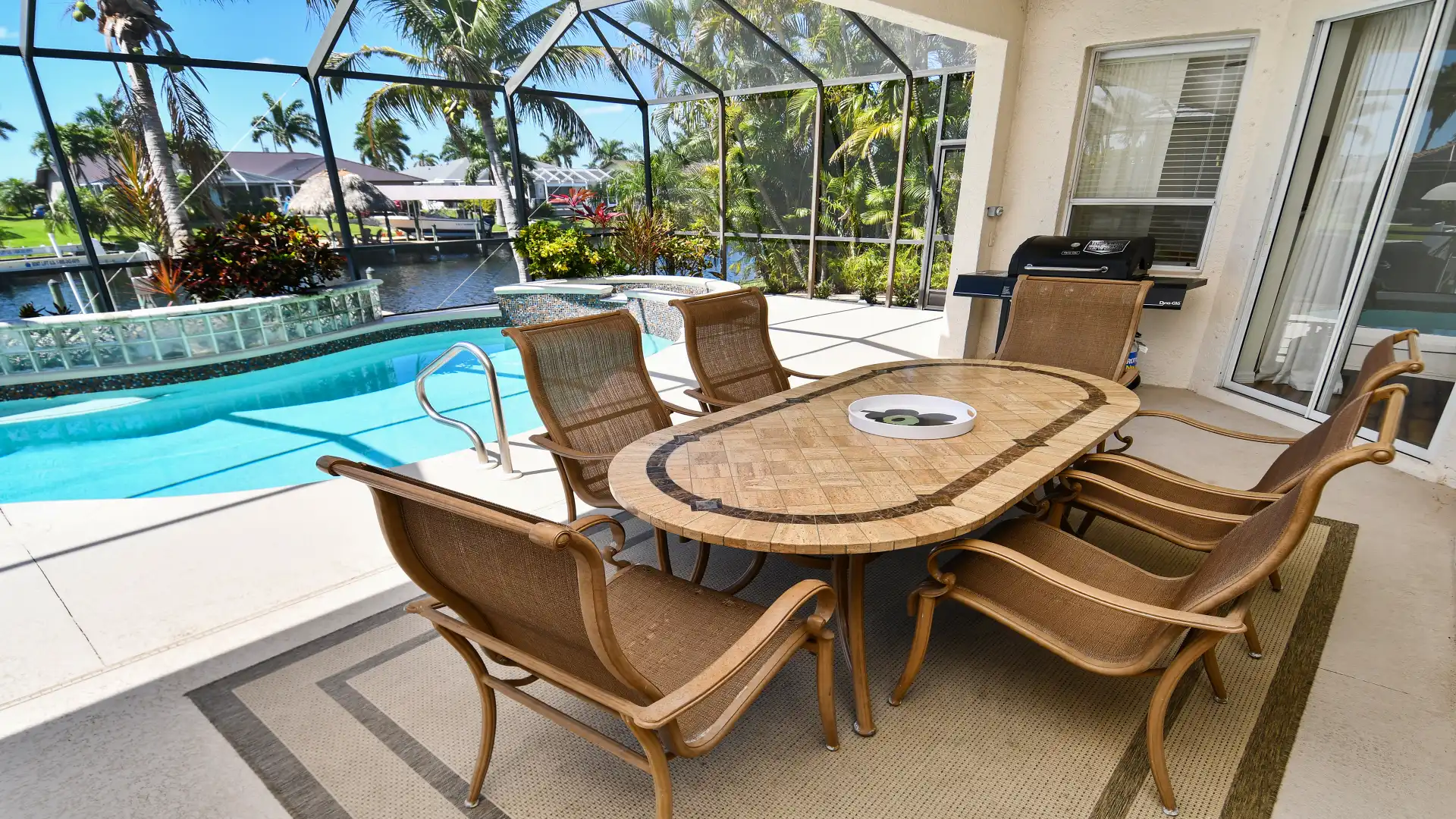 Modern patio furniture and a BBQ on the covered terrace