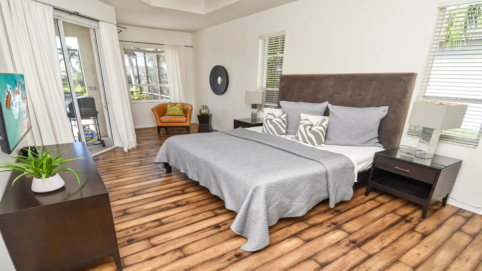 Master bedroom with oversized double bed and exceptional floorboards and access to the terrace