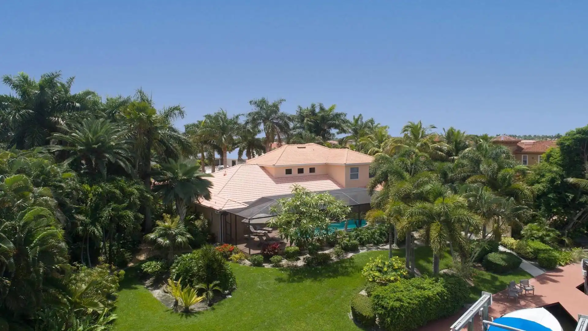 The home is situated in a park-like setting with numerous palm trees