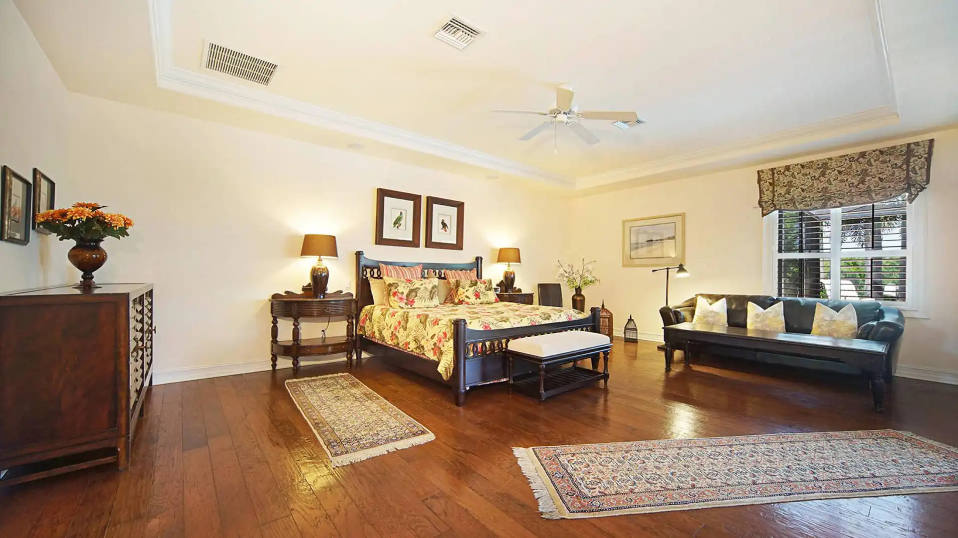The master bedroom is spacious enough to accommodate a sofa