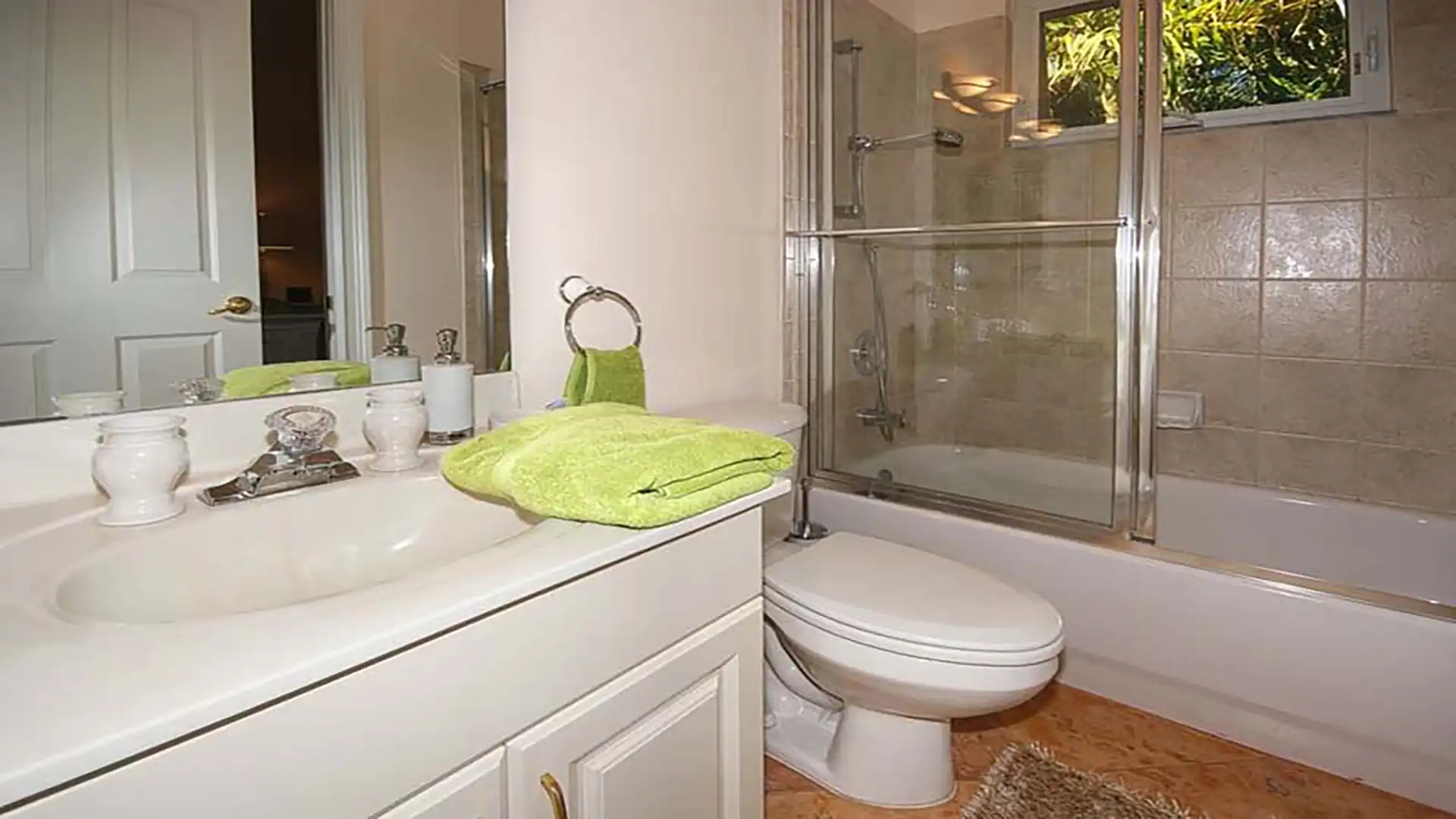 Bathroom with bathtub shower, sink and toilet