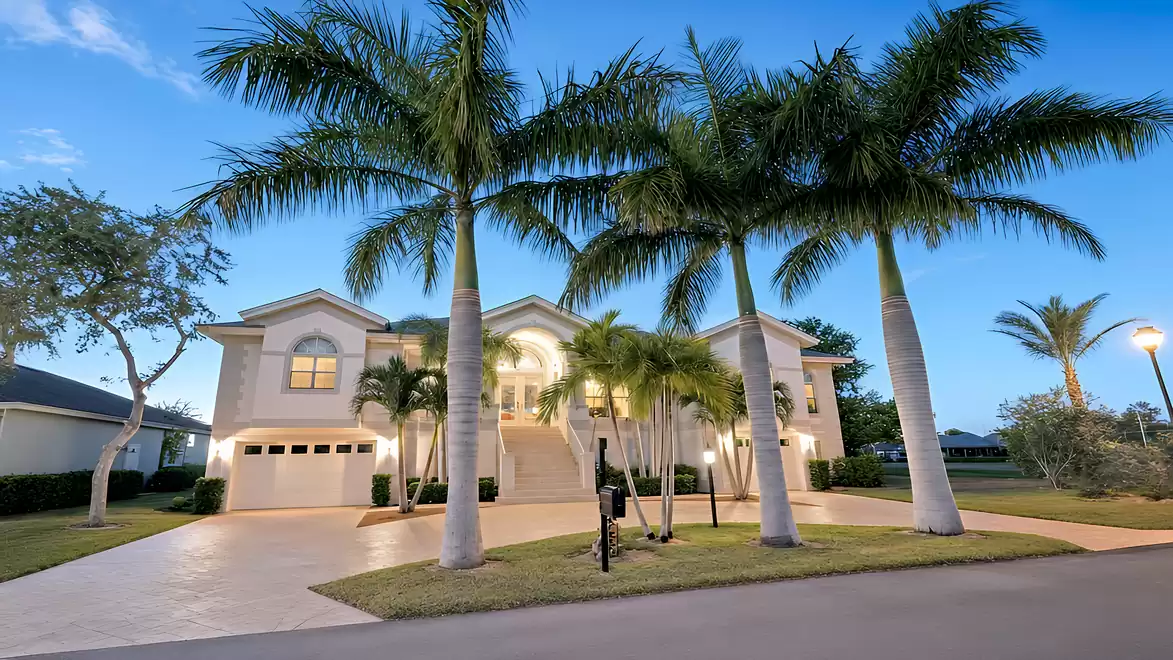 The luxurious property is surrounded by palm trees