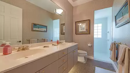 The guest bath includes double sinks and a walk-in shower