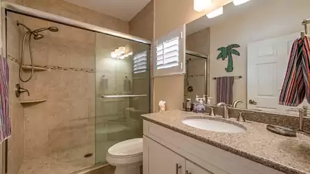 The guest bathroom offers a glazed 